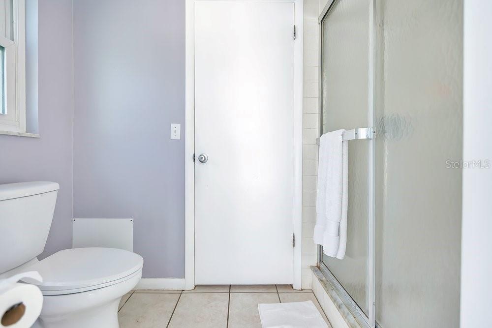 Primary water closet has pool access with shower and door that can be shut from the bedroom