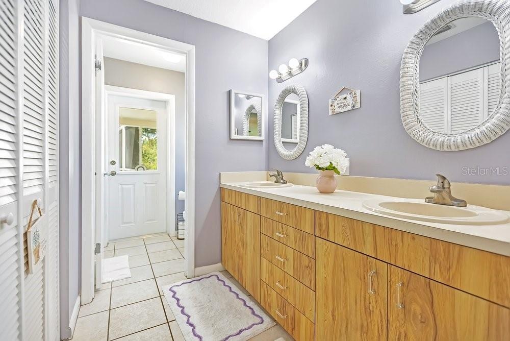 Dual sinks with walk in closet and access to pool area