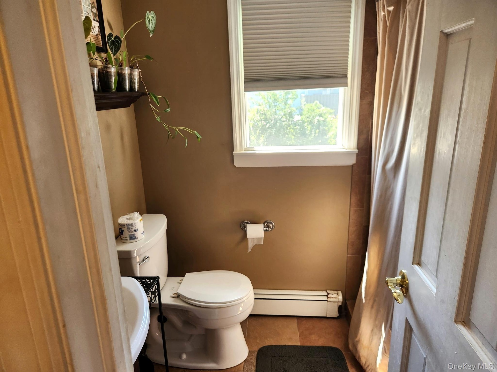 Bathroom with window and cellular shades