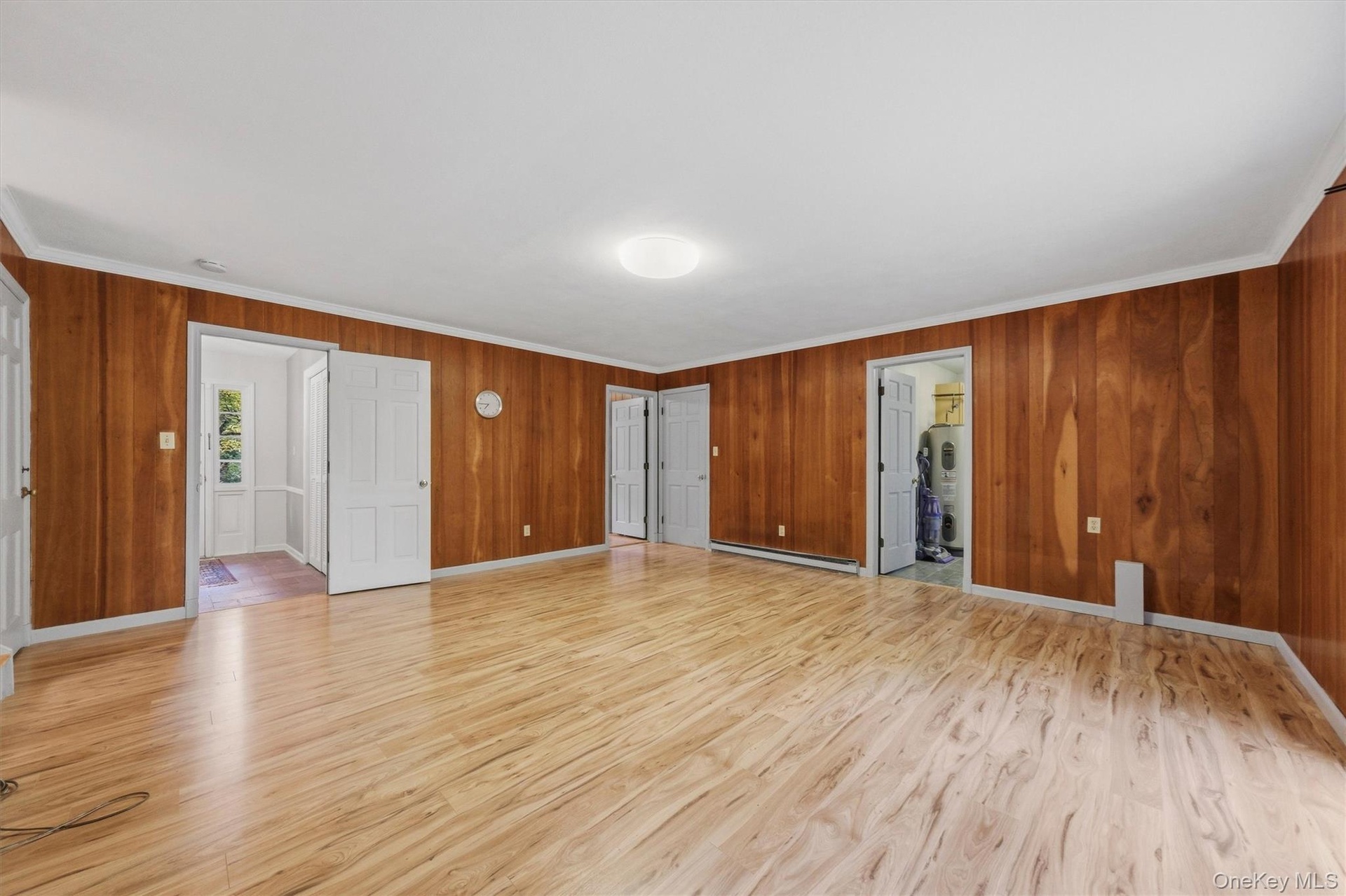 Enormous family room with new laminate floors and SGD to private backyard and patio