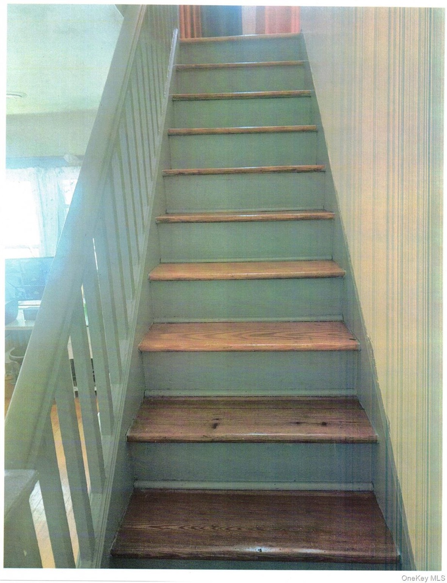 Staircase with wooden-finish treads and painted risers