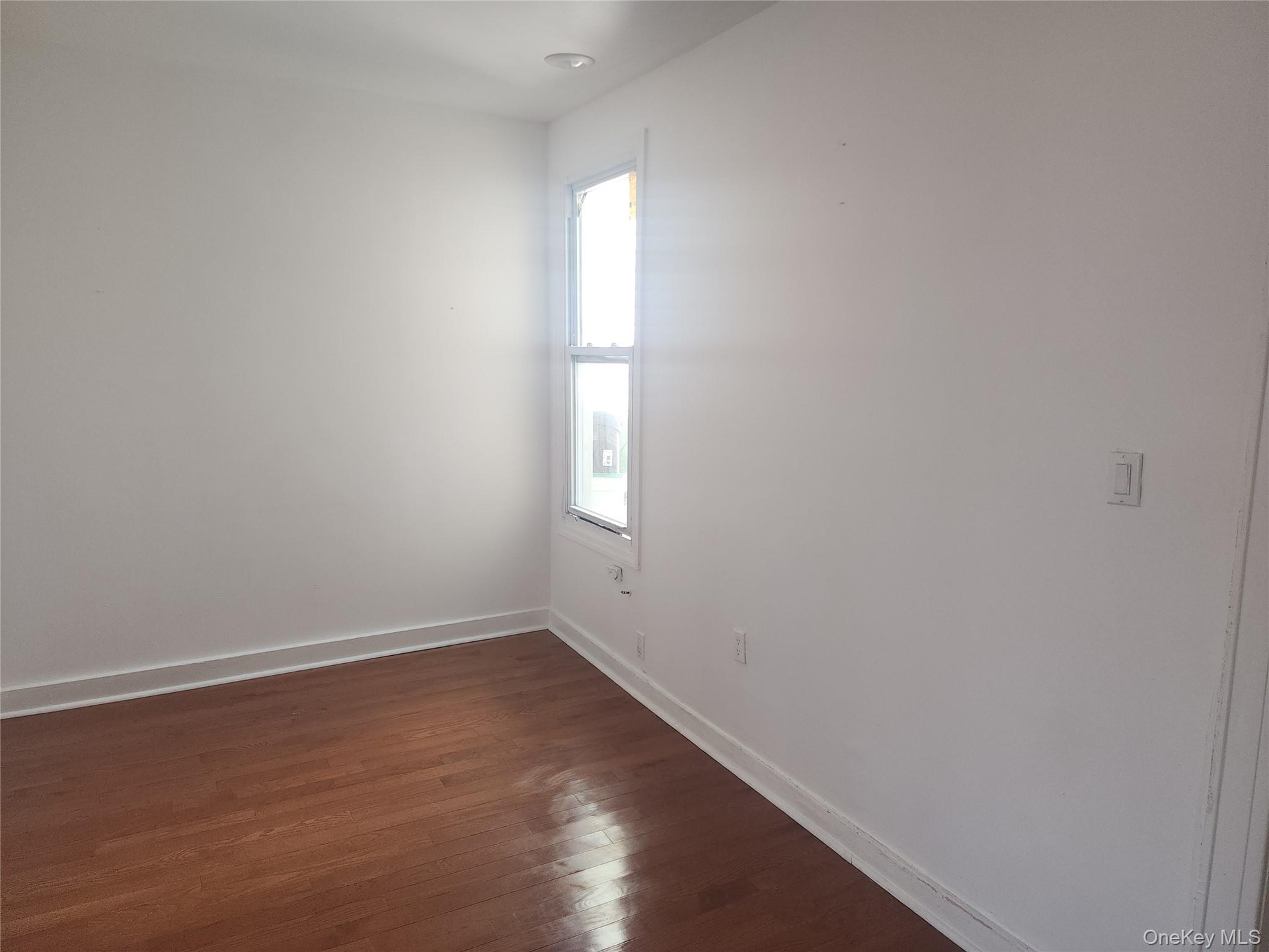 Hardwood flooring, painted walls, single window, recessed lighting, white trim