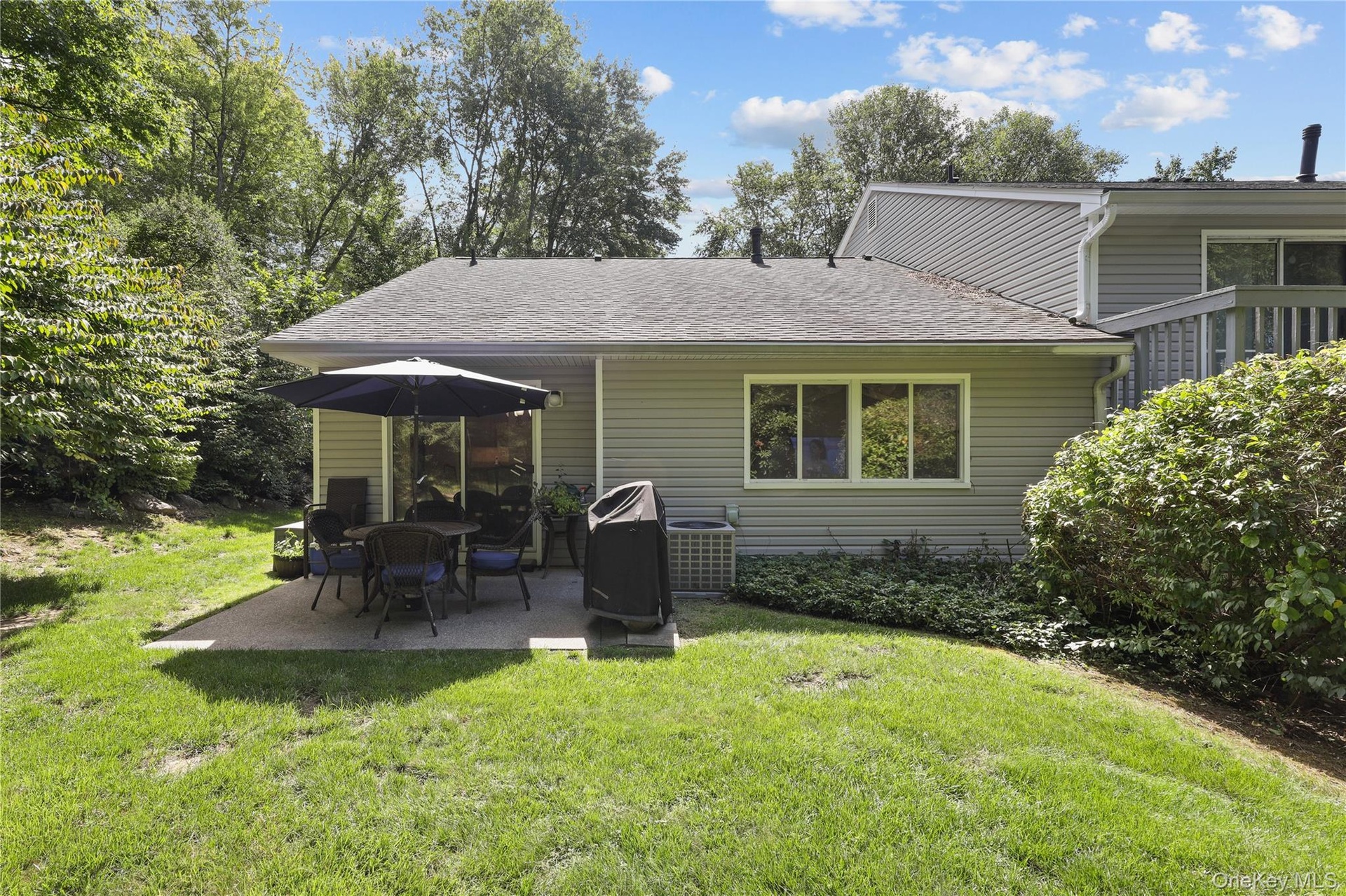 End unit providing level patio and room for barbecue