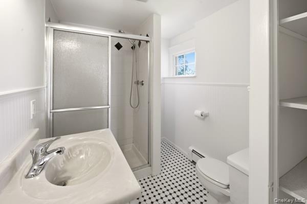 Second floor ceramic tile bathroom with window and linen closet