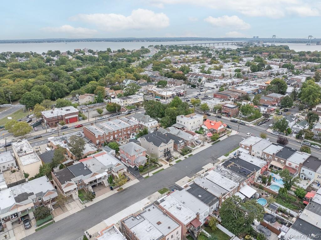 Aerial view of property and surrounding area with a large body of water