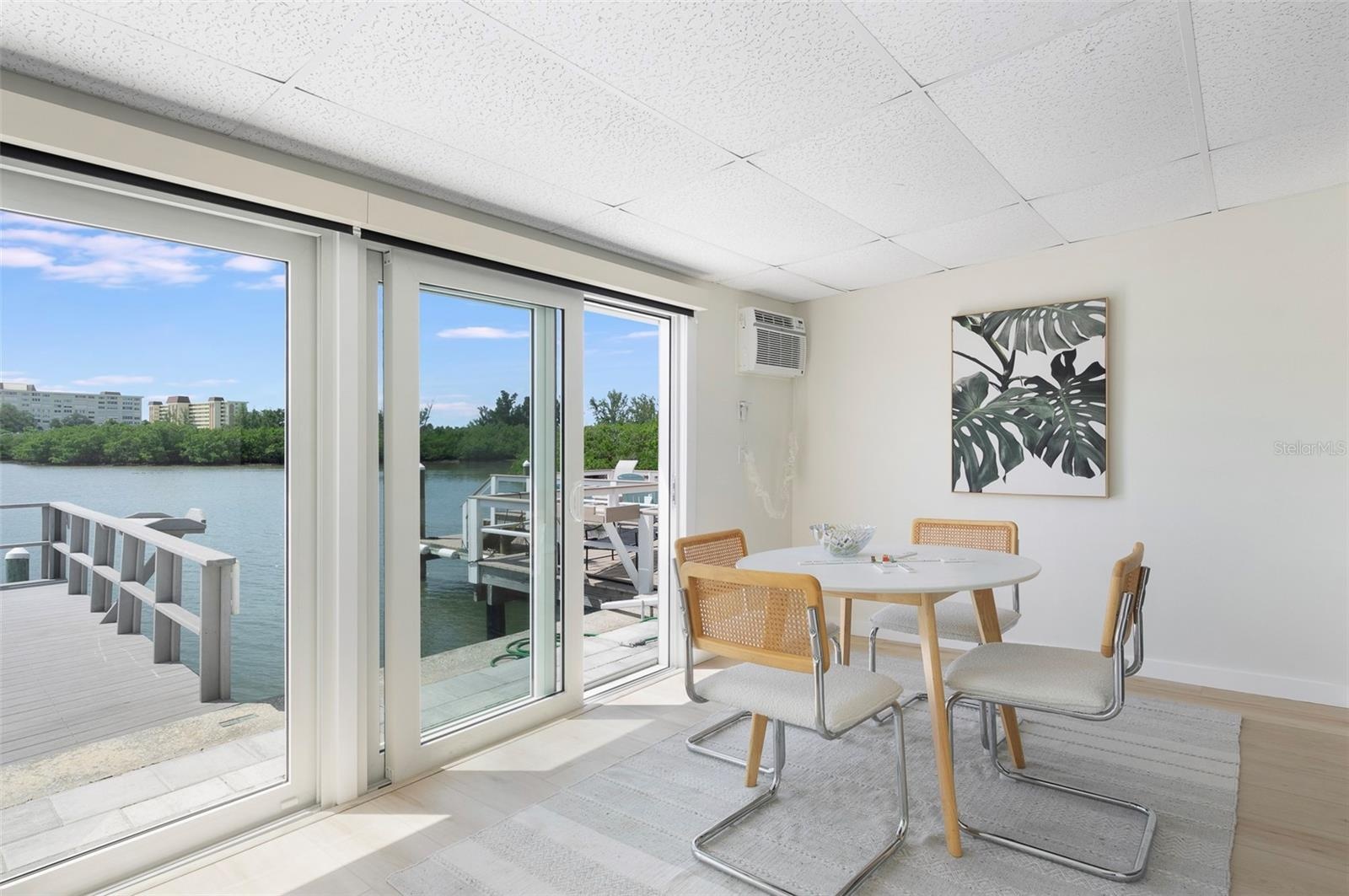 Flex Florida room features hurricane sliding glass doors. Remote Shades, too