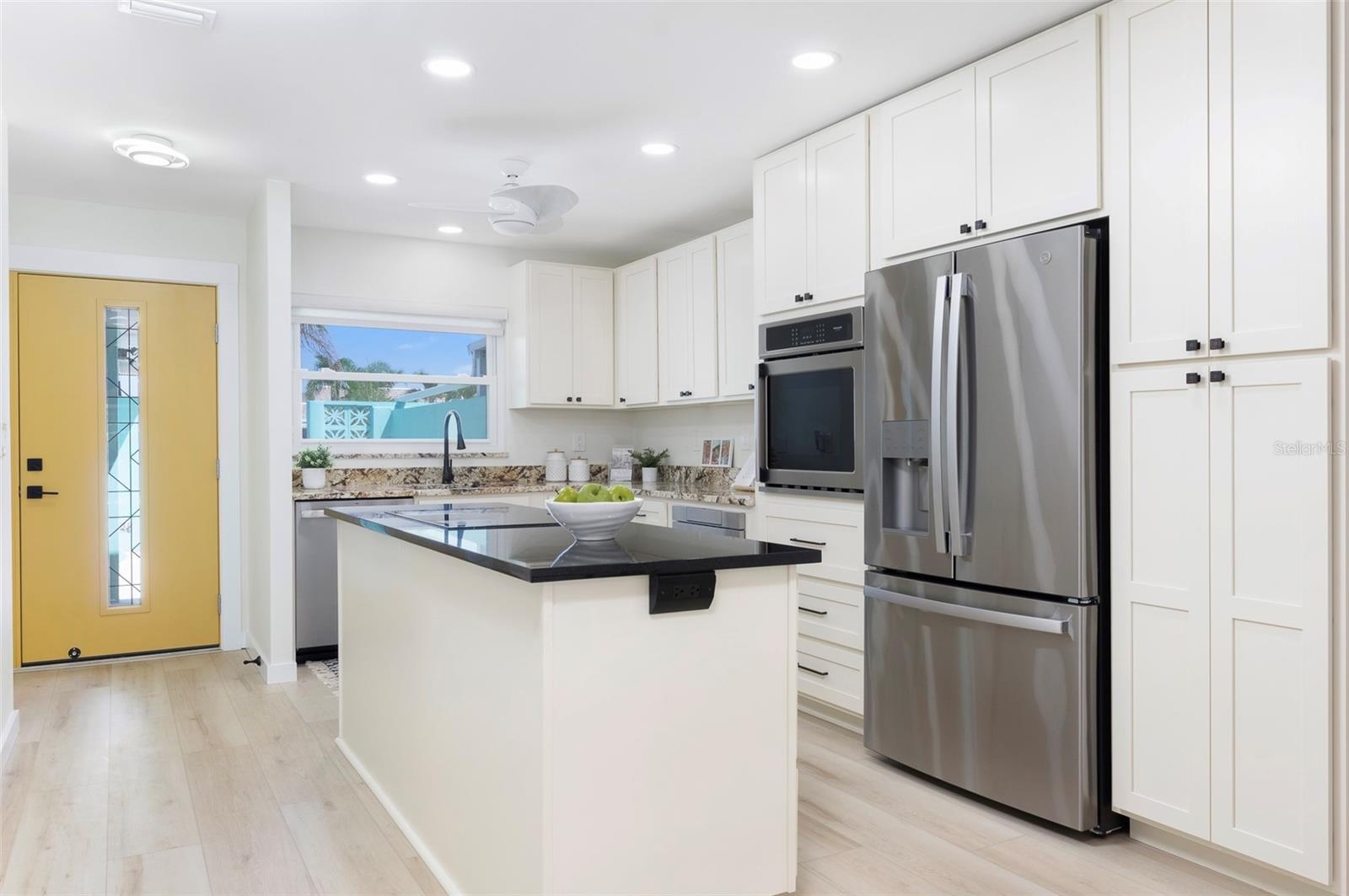 An entry breaks up the home. The kitchen has plenty of storage and counter space.