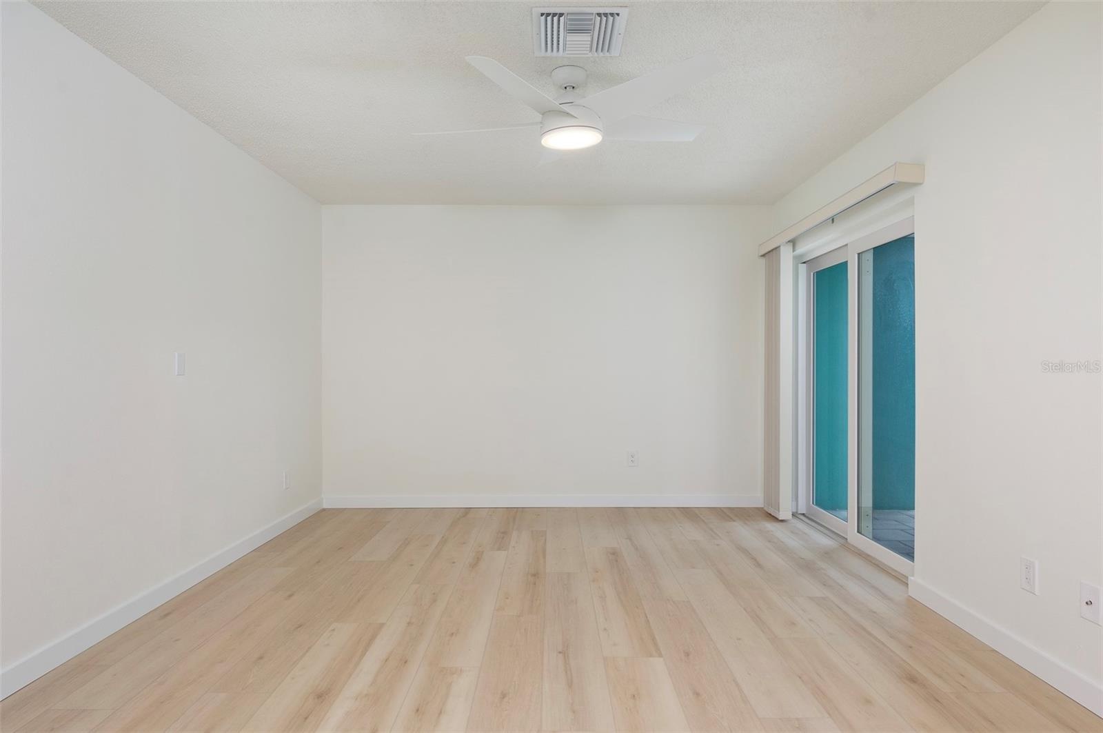 Split Plan Bedroom #2 in the front of the house. Hurricane-rated sliders lead out to your private courtyard.