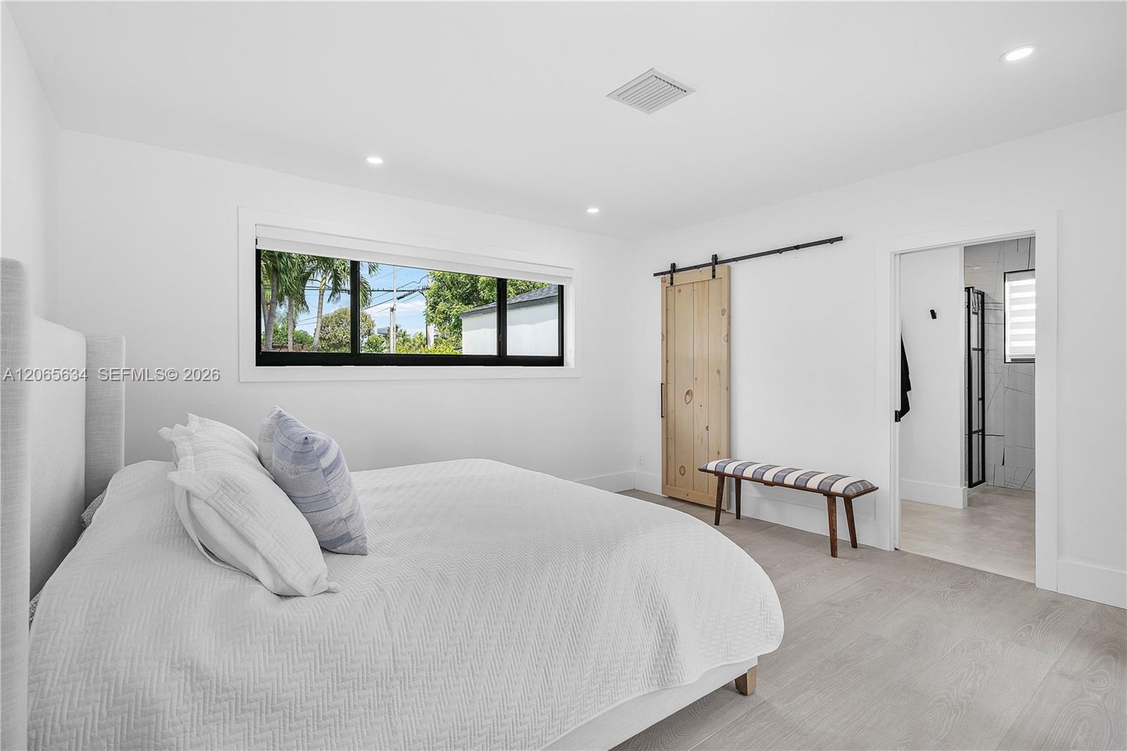 LARGE MAIN BEDROOM WITH SLIDING BARN DOOR