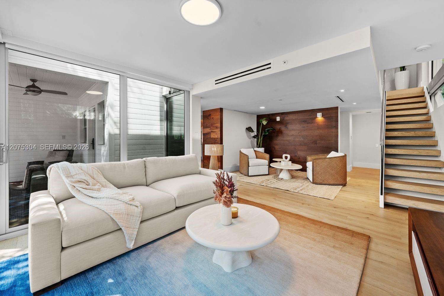 Spacious living area with clean lines, recessed lighting, and open flow to dining and kitchen — perfect for entertaining.
