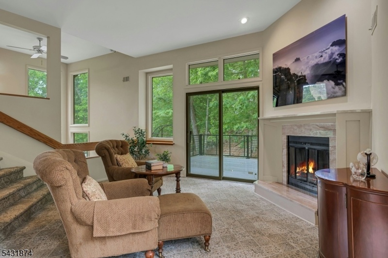 Den with Fireplace and Deck