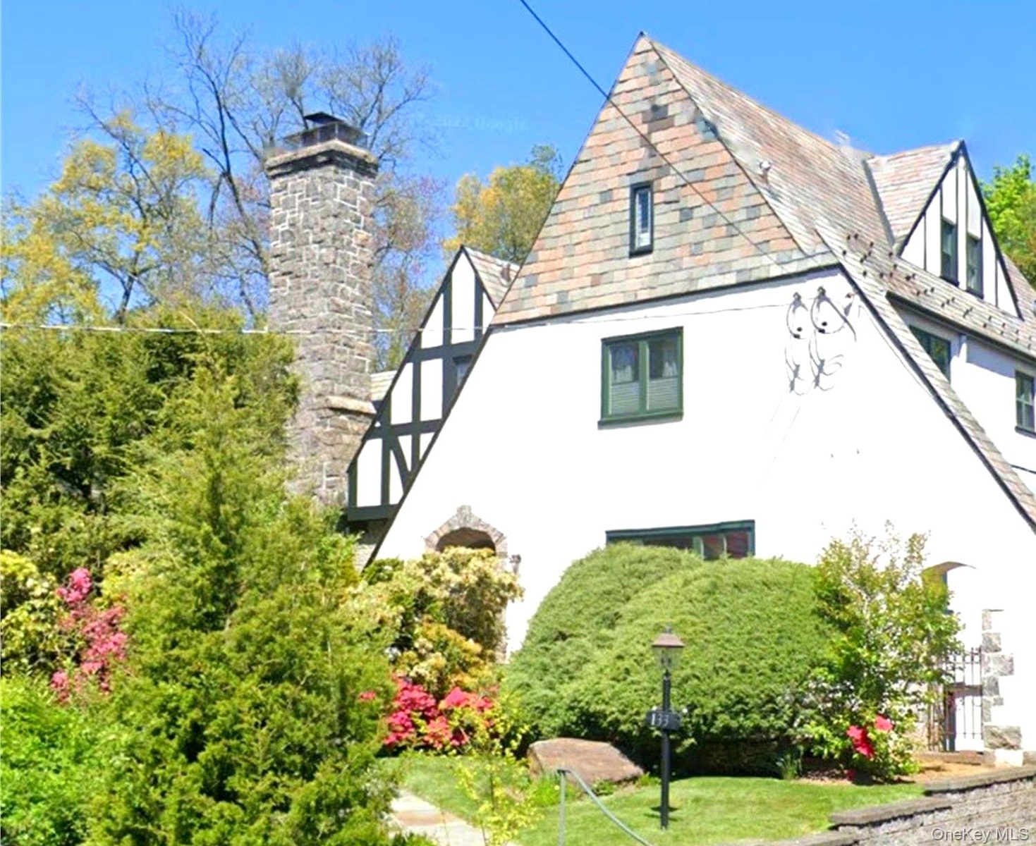 Offered for the first time in over 20 years, 133 Bon Air Avenue is a timeless Tudor distinguished by its iconic stone chimney, classic architecture, a