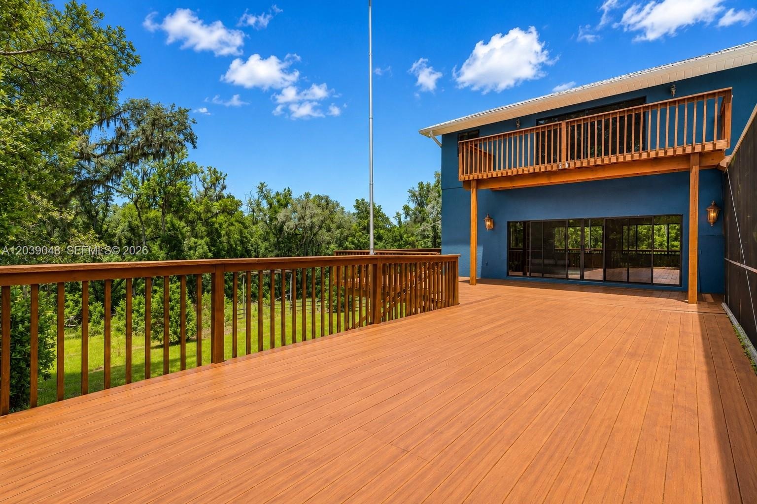 Expansive two-story wraparound deck spanning three sides of the home, ideal for outdoor entertaining and scenic enjoyment.