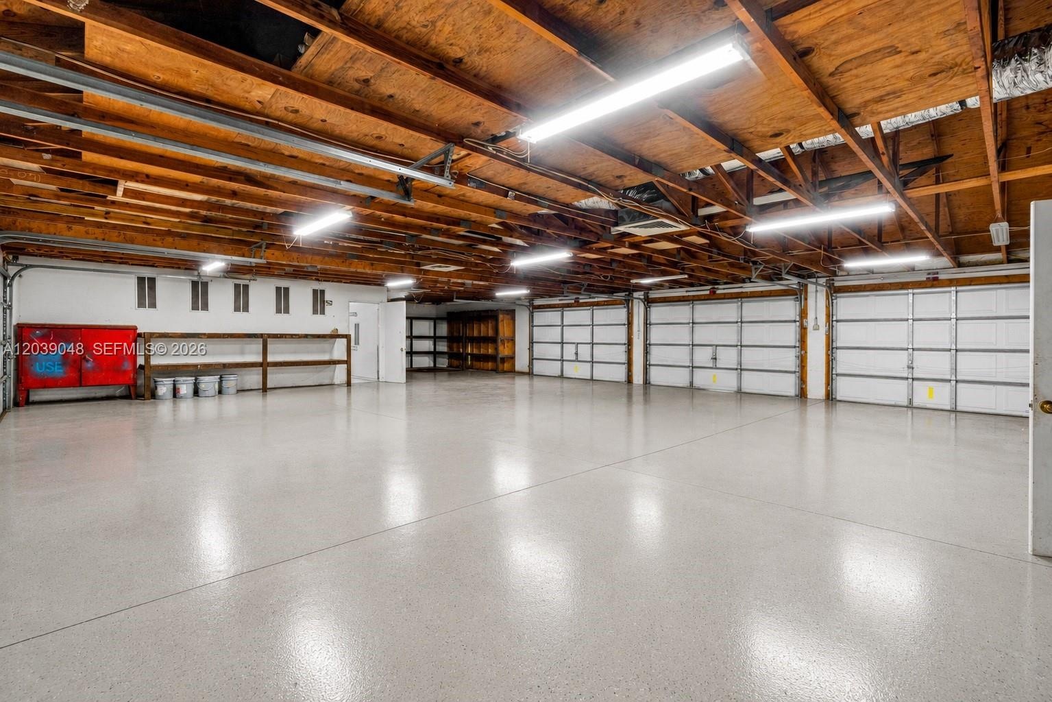 Expansive garage infrastructure featuring two separate buildings with combined 8-car capacity, ideal for collectors or those seeking elevated storage 