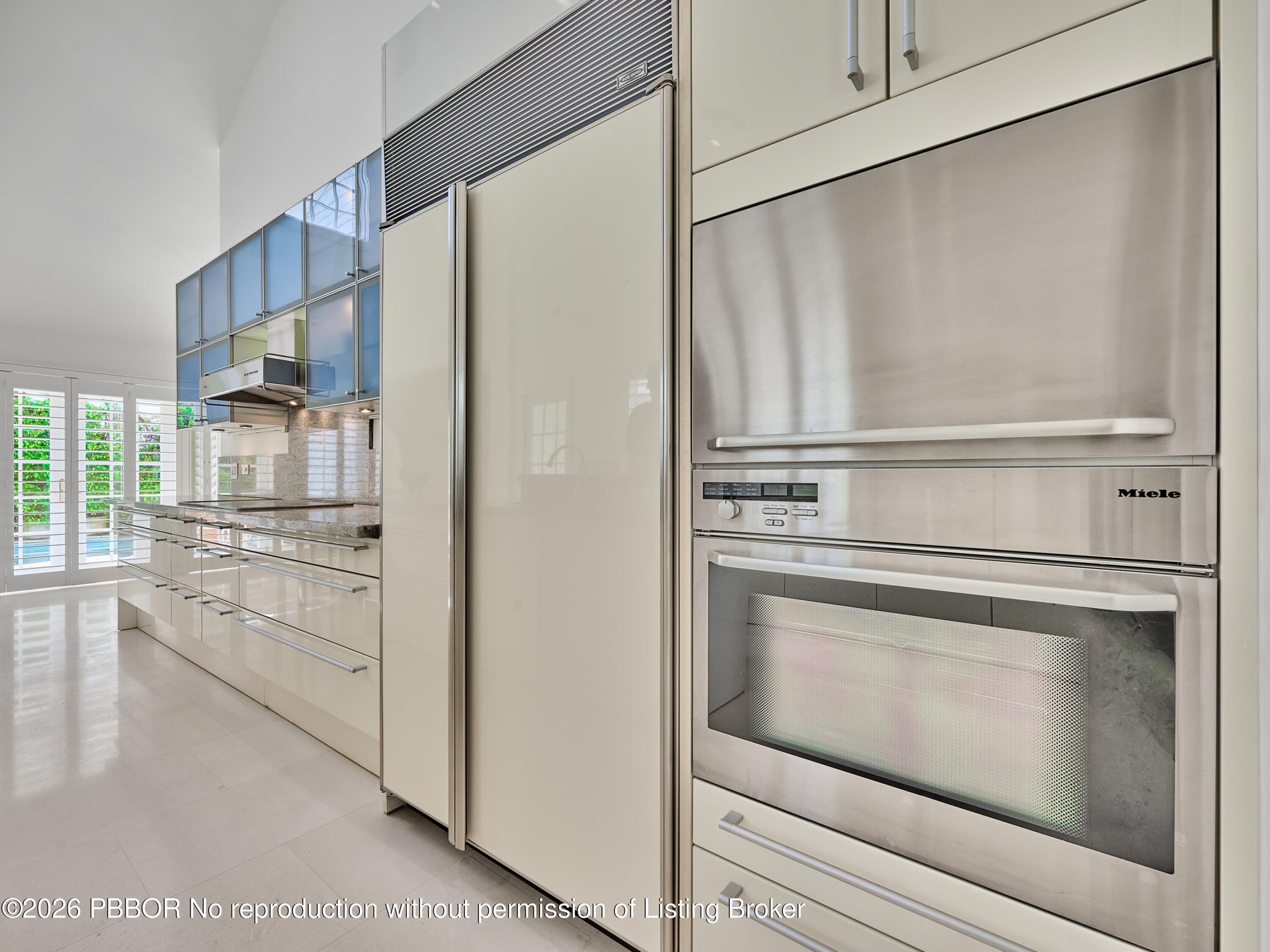 Volume Ceilings, French Doors, Wall of Windows and Dormers bring Natural Light into the Kitchen all day
