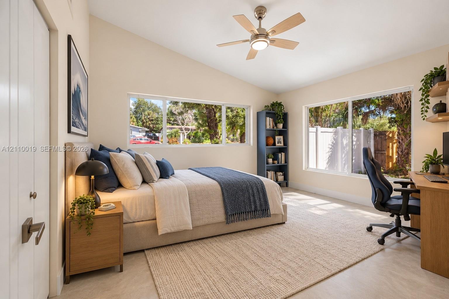Vaulted ceilings, large picture windows, and a ceiling fan with integrated lighting