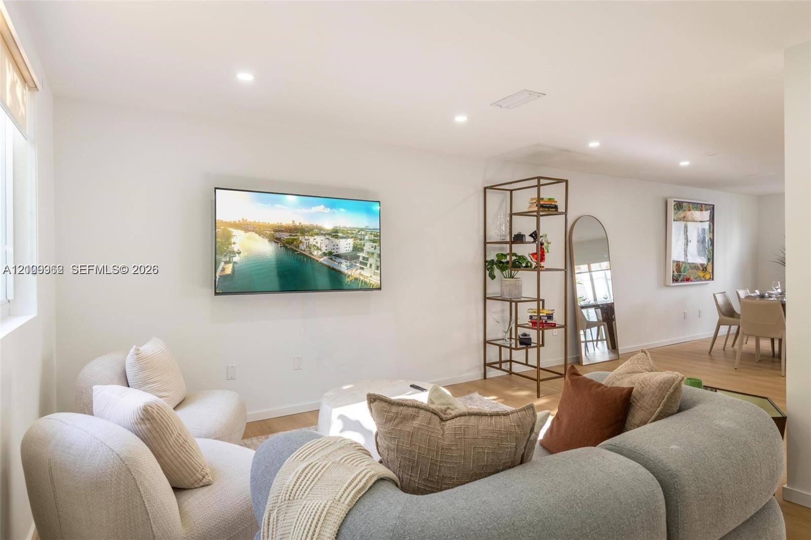 Neutral interior space featuring smooth walls, recessed ceiling lighting, and wood-finish flooring