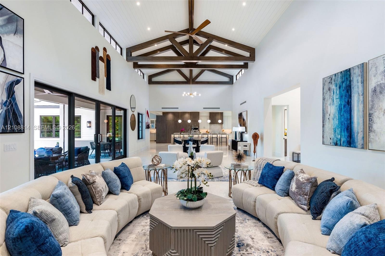 Vaulted ceilings with exposed decorative timber trusses and beadboard paneling, clerestory windows, and large-format tile flooring