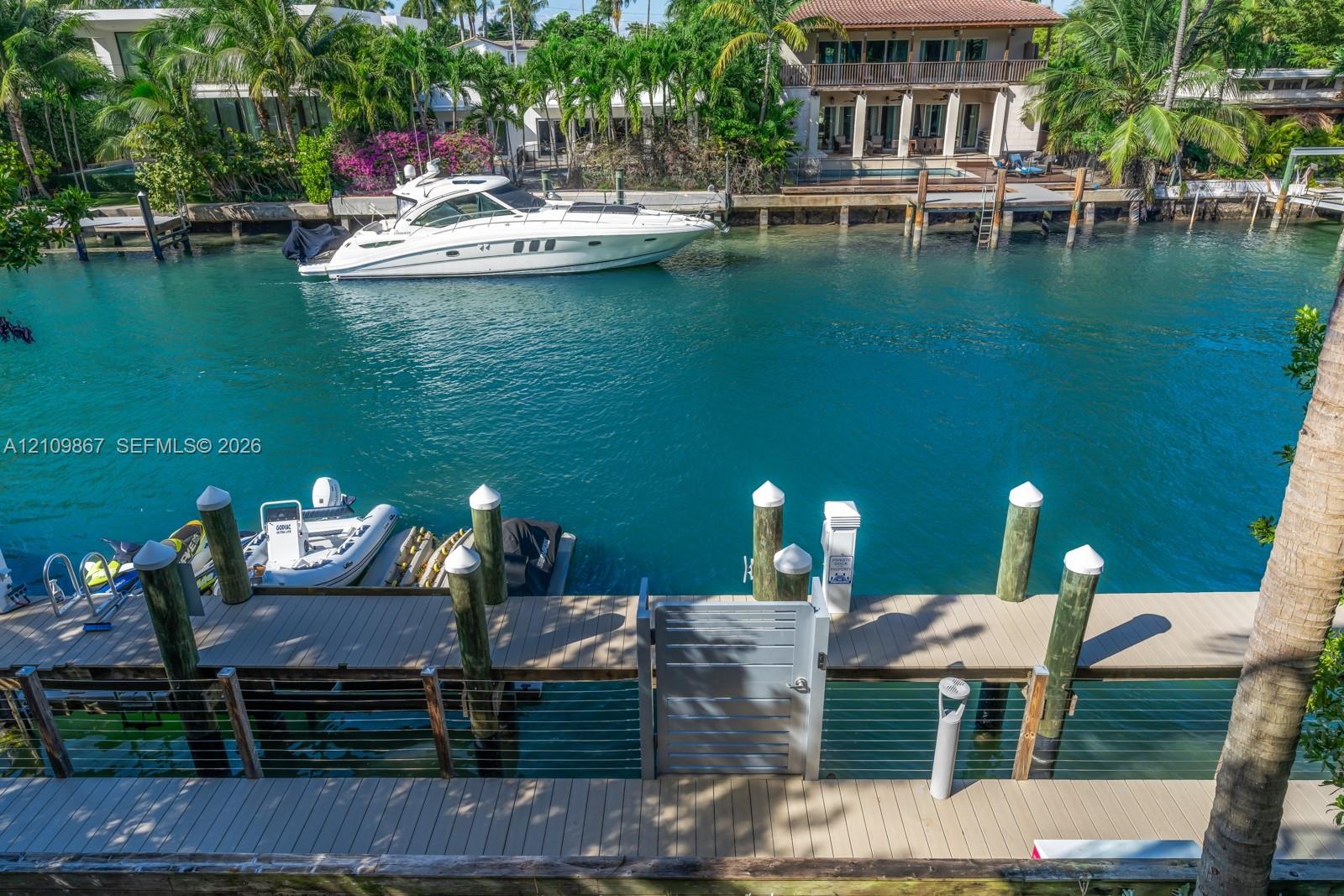 Waterfront bulkhead with composite decking, cable railing, locking gate, and pilings