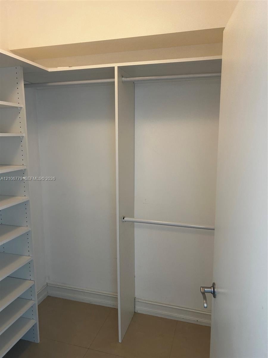 Built-in storage system featuring floor-to-ceiling shelving and dual-tier hanging rods