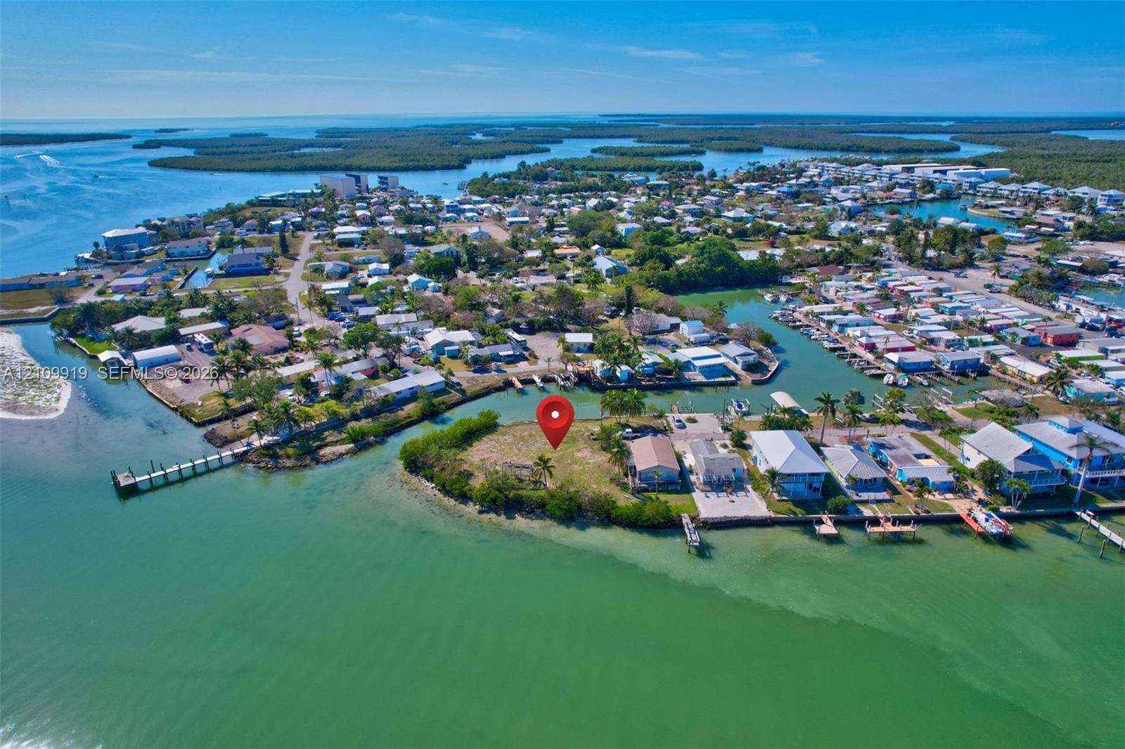 Waterfront parcel featuring direct canal access, expansive shoreline, and mature tropical vegetation