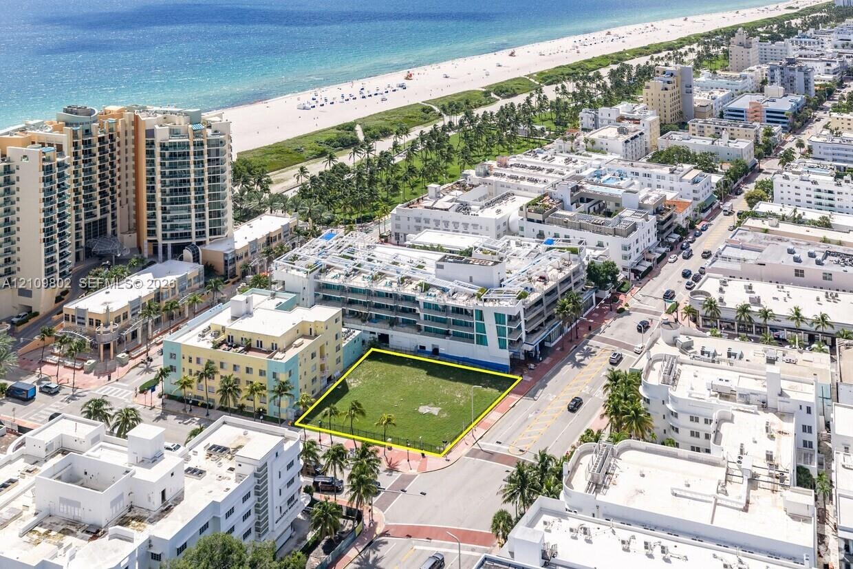 Corner lot featuring expansive grass grounds and mature palm trees, positioned within an urban coastal setting