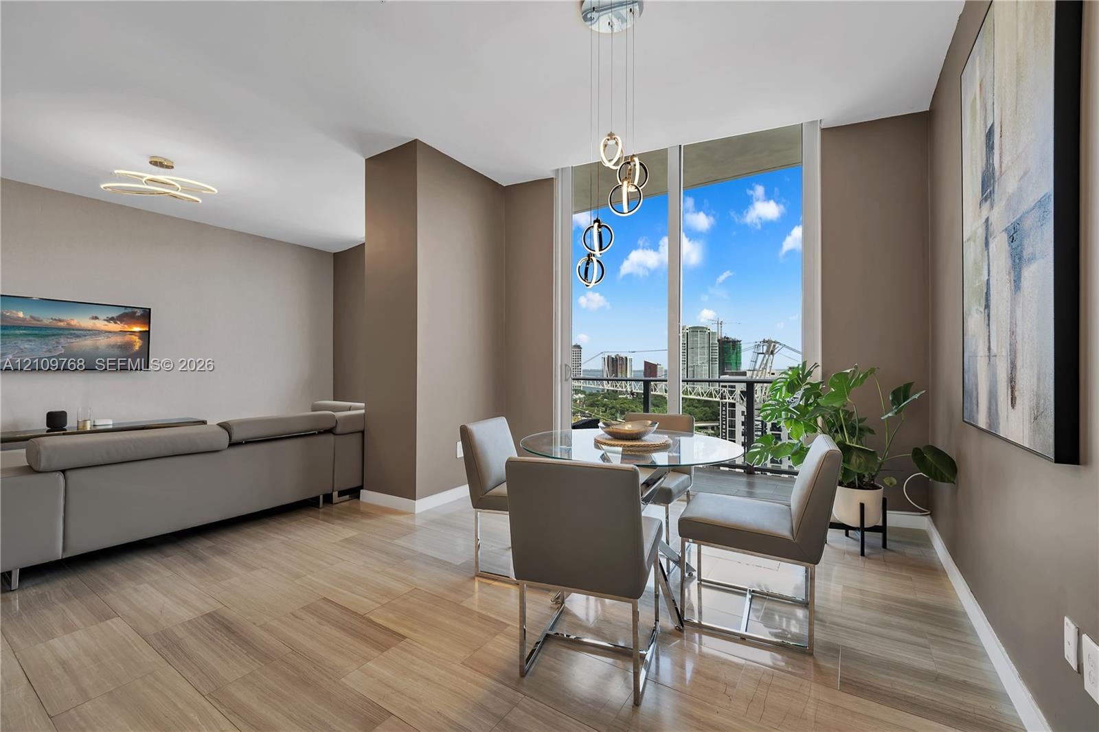 Floor-to-ceiling windows, wood-finish tile flooring, contemporary multi-tier chandelier, and recessed ceiling lighting