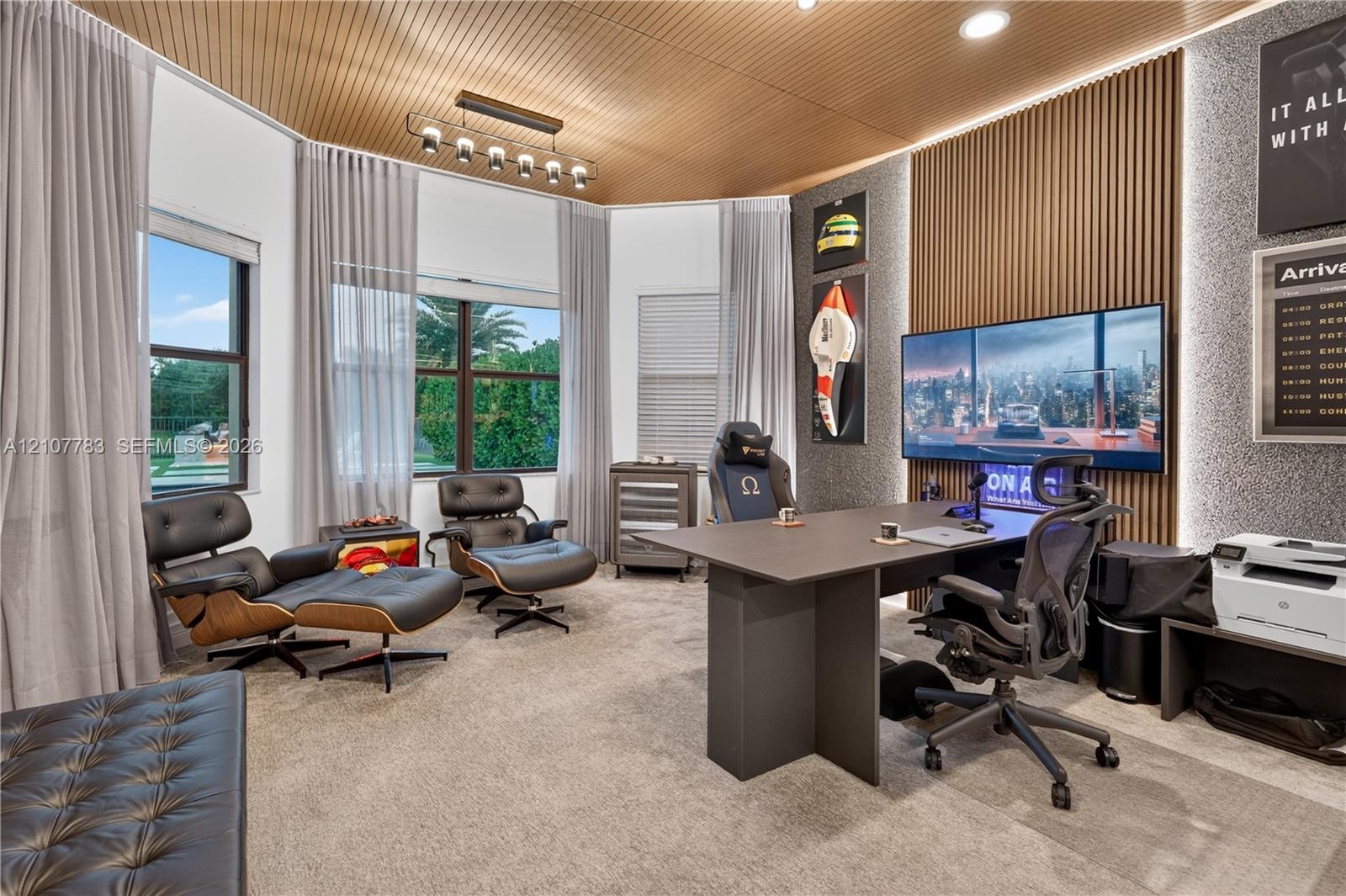 Curved wood-slat ceiling, vertical wood-slat feature wall with integrated LED accent lighting, multi-pane windows, and linear overhead pendant lightin