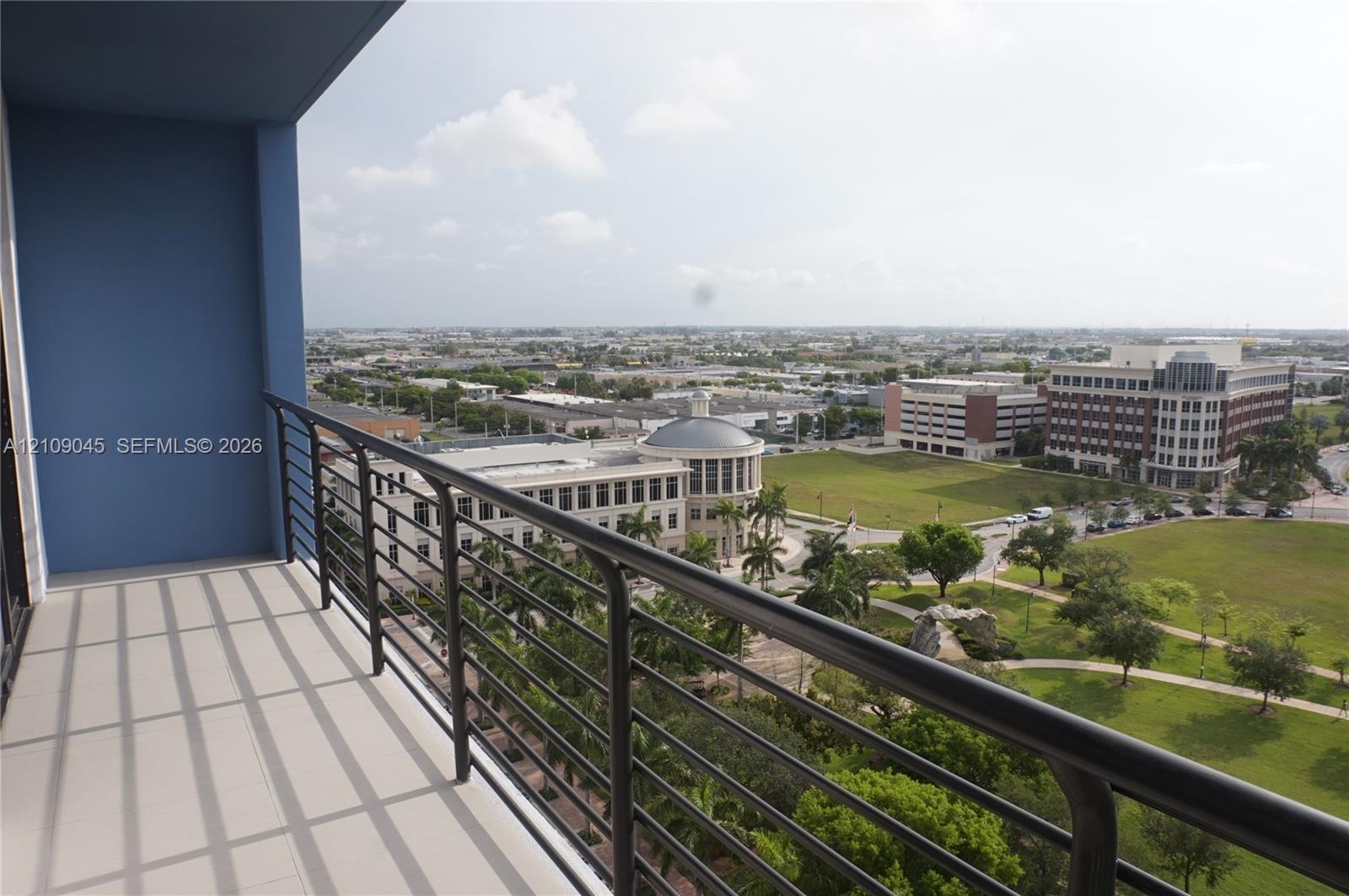 Covered balcony featuring tile flooring and metal railings