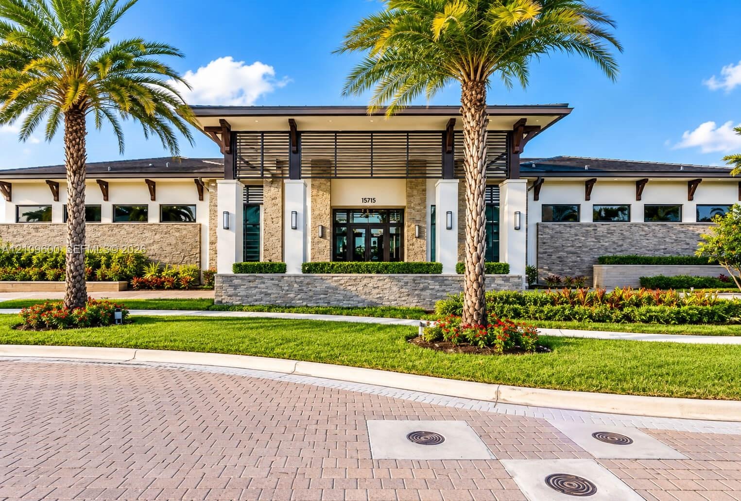 Architectural exterior featuring stacked stone facade, expansive overhanging eaves with decorative corbels, horizontal wood-slat detailing, manicured 