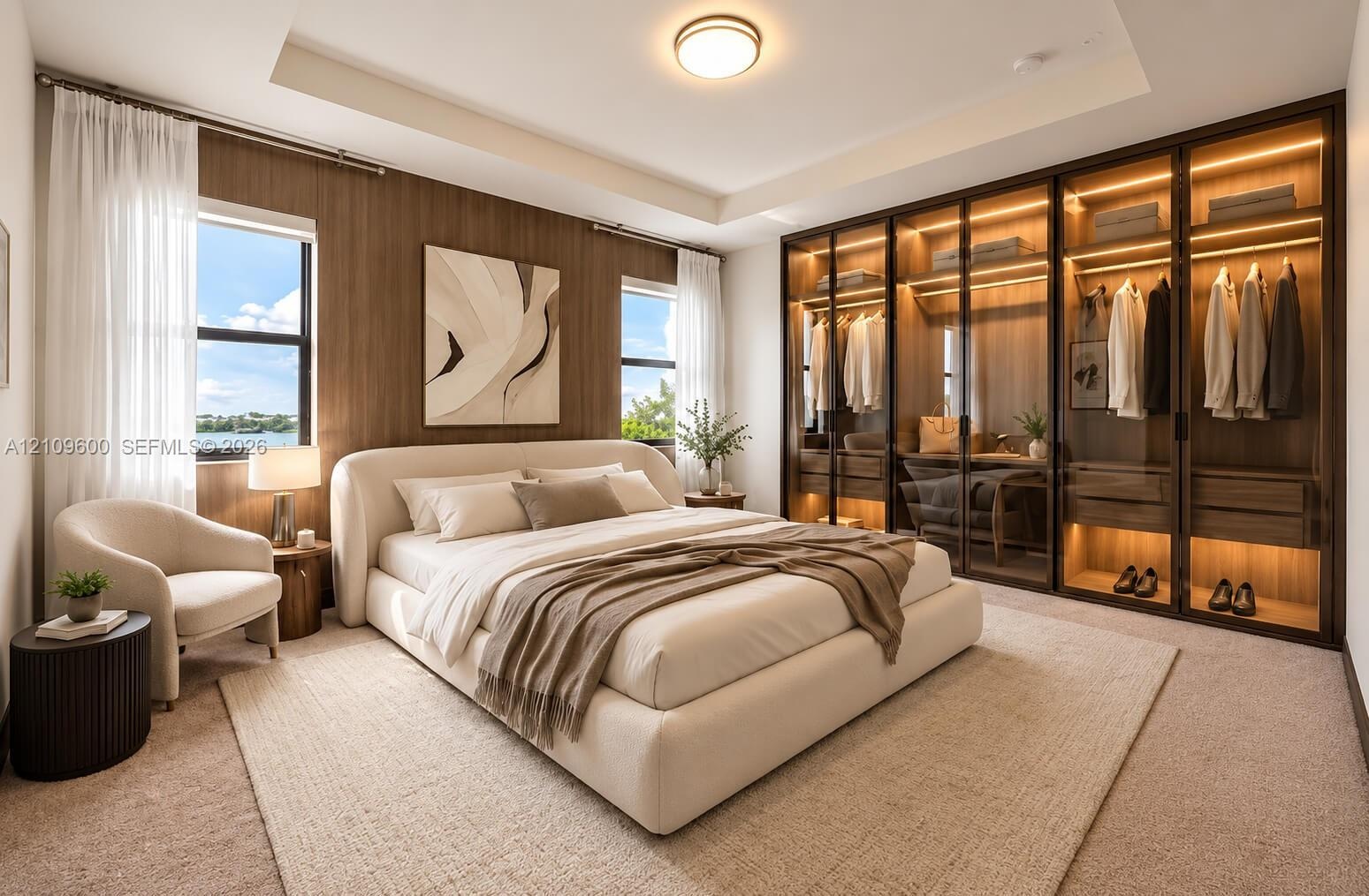 Bedroom featuring a tray ceiling, recessed lighting, wood-paneled accent wall, and floor-to-ceiling glass-front wardrobes with integrated interior lig