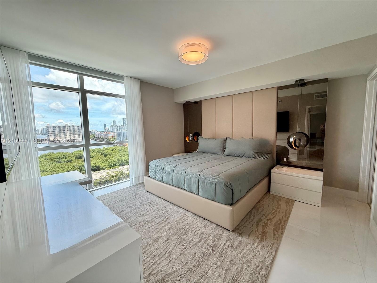Floor-to-ceiling windows, polished stone flooring, integrated mirrored wall panels, and flush-mount lighting