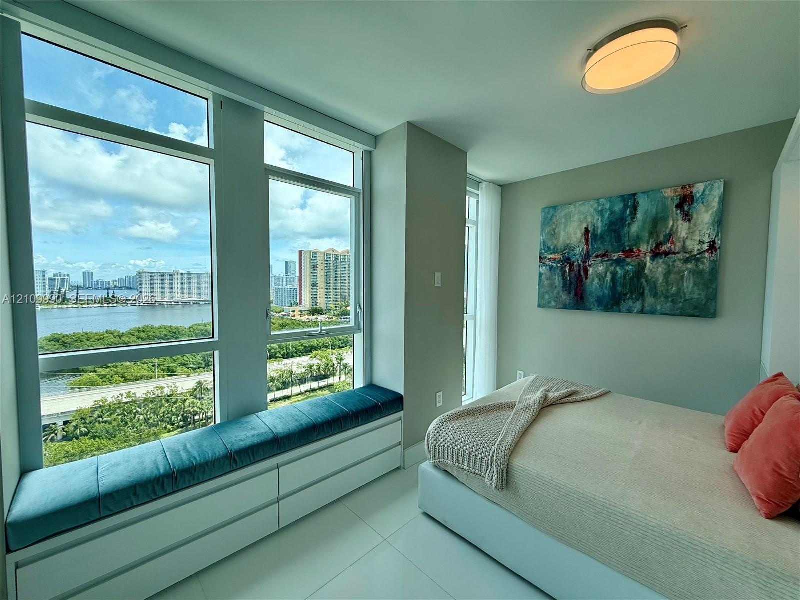 Floor-to-ceiling windows, built-in window seating with integrated cabinetry, polished tile flooring, and flush-mount ceiling lighting