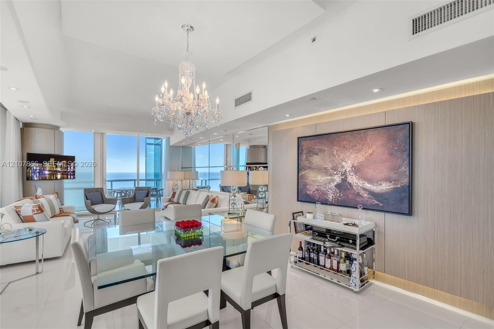 Expansive floor-to-ceiling glass windows, custom wood-paneled feature wall with integrated accent lighting, polished tile flooring, and decorative cry