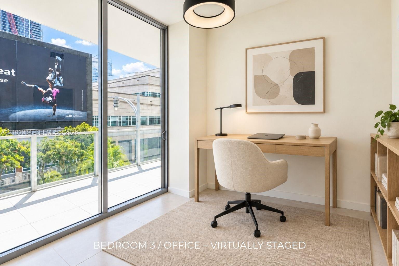Floor-to-ceiling sliding glass door, private balcony with metal railing, neutral tile flooring, and circular modern pendant light fixture