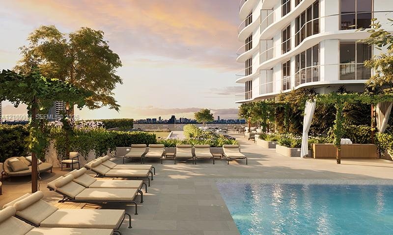 Outdoor terrace featuring a swimming pool, stone-finish decking, tiered landscaping, and pergola structures