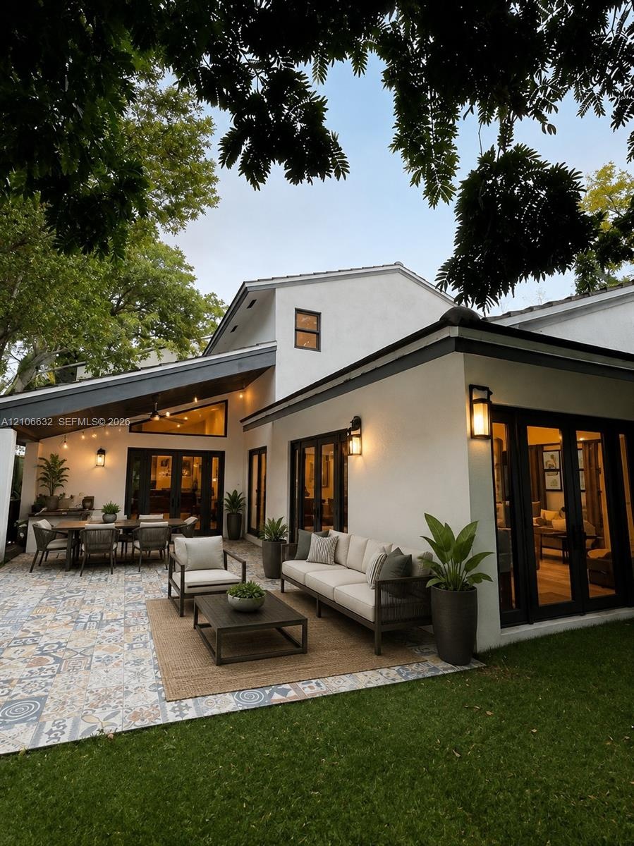 AI enhanced photo. Patio featuring patterned tile flooring, covered architectural overhang, exterior wall-mounted lighting, and double glass-paned doo