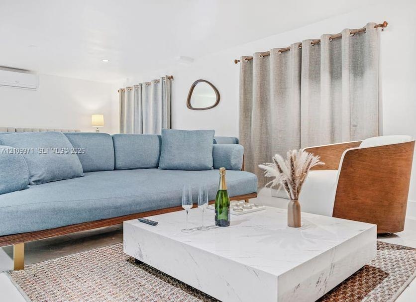 Neutral interior featuring white walls, wall-mounted ductless air conditioning unit, and metal curtain rods