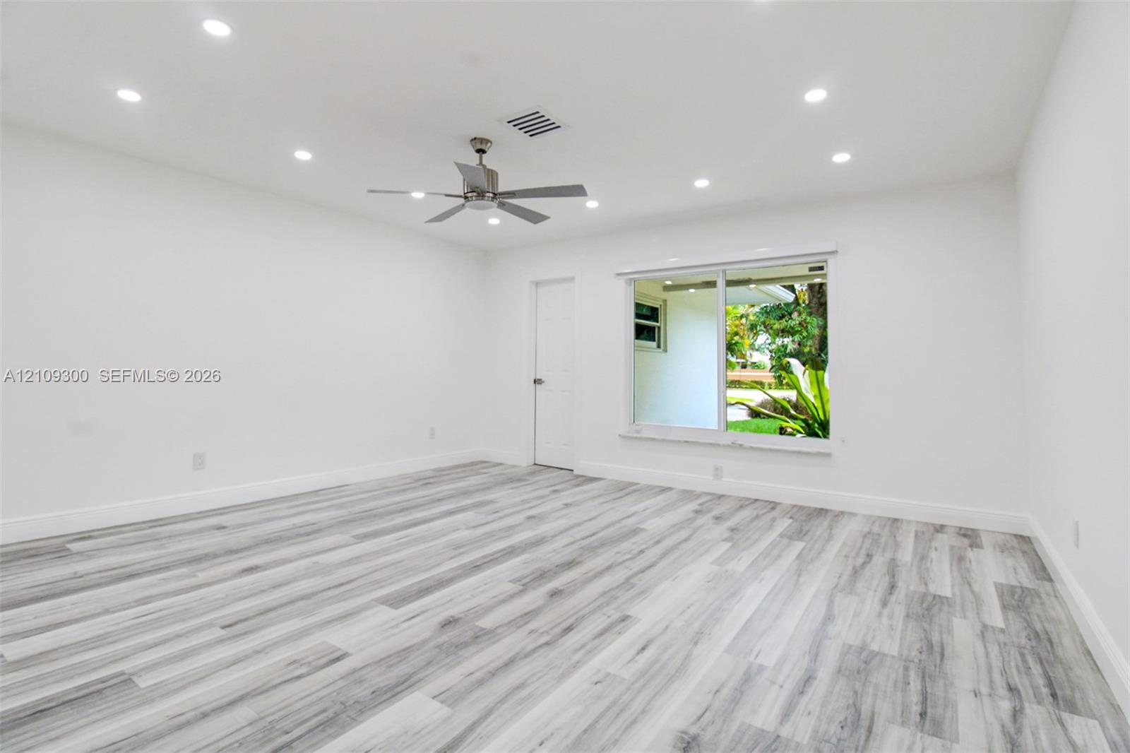 Interior space featuring wood-finish flooring, recessed lighting, and a metal-finish ceiling fan
