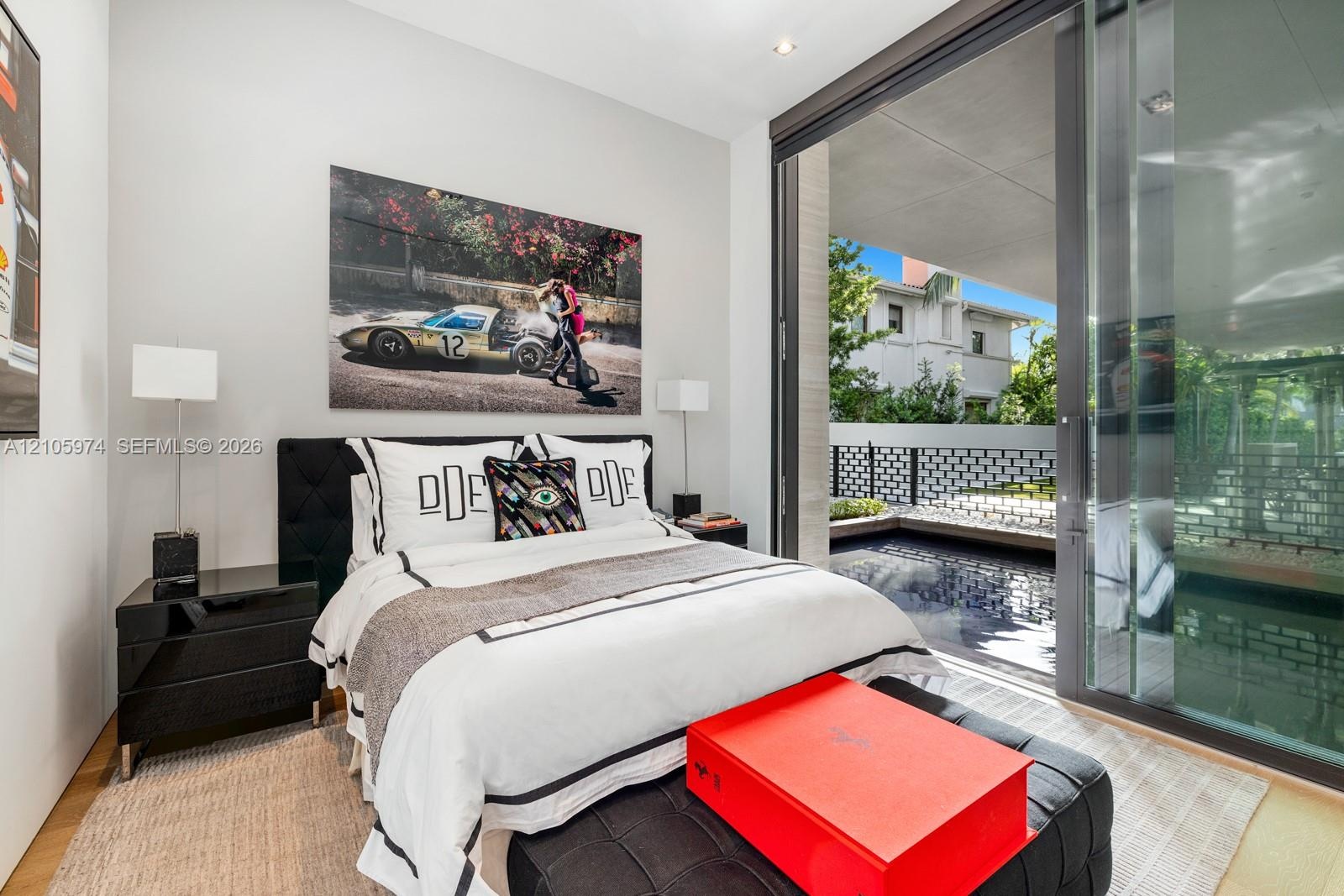 Floor-to-ceiling sliding glass panels, recessed ceiling lighting, and wood-finish flooring