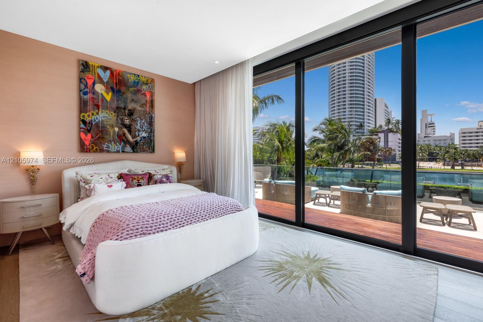 Floor-to-ceiling glass sliding doors, private balcony with wood-finish decking, glass railing, and neutral wall textures