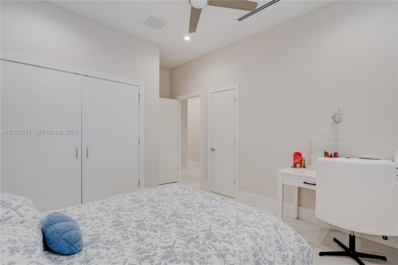 Neutral-toned room featuring a ceiling fan with integrated lighting, recessed lighting, and a double-door closet