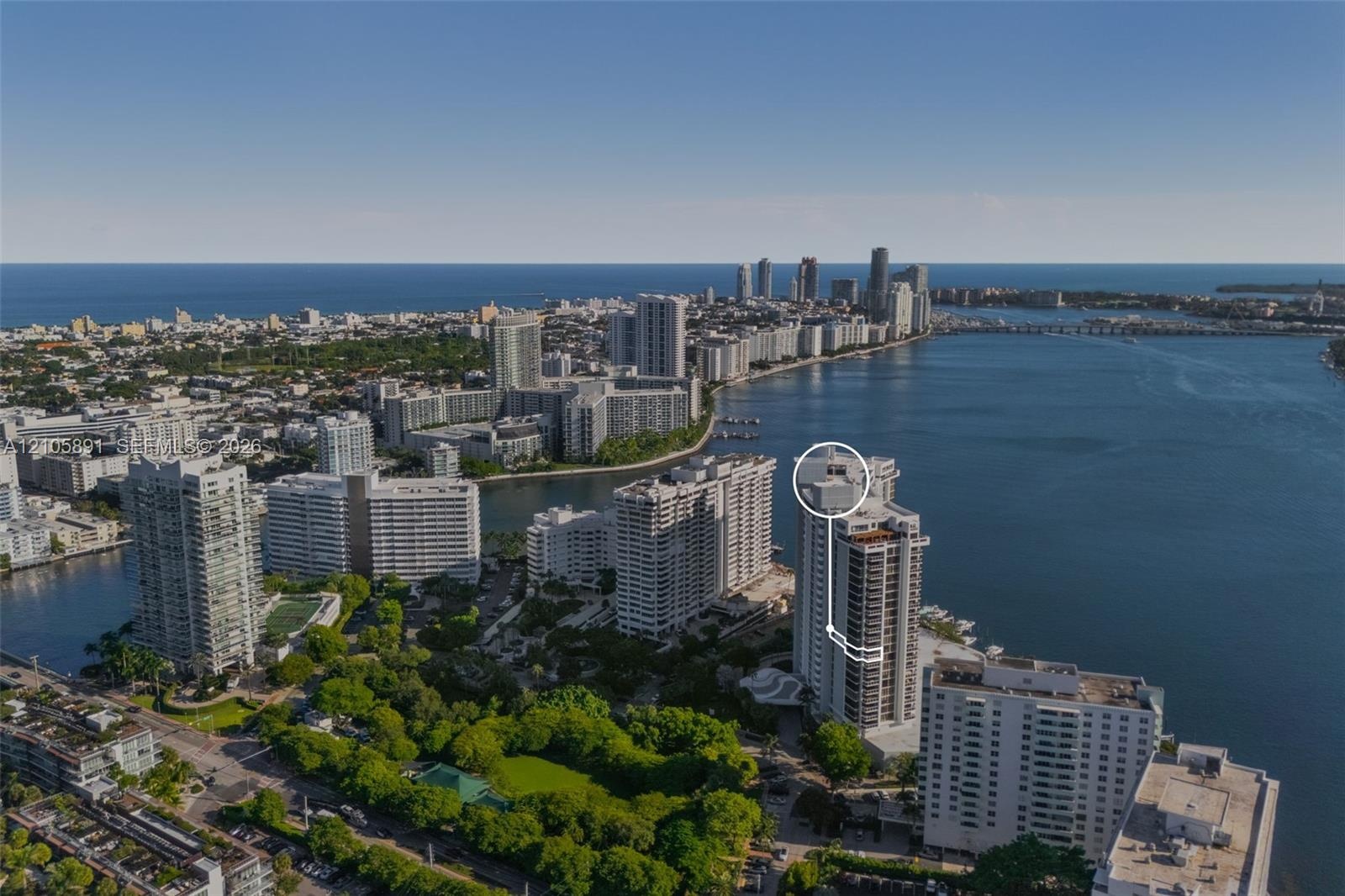 Aerial perspective of coastal high-rise residence featuring direct water frontage, proximity to the coastline, and a prominent position within a dense