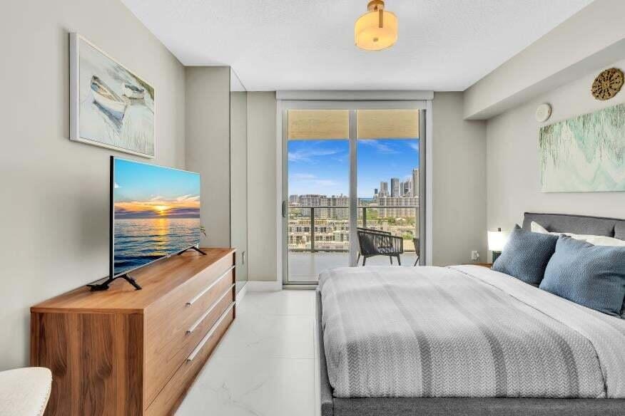 Floor-to-ceiling sliding glass doors open to a private balcony