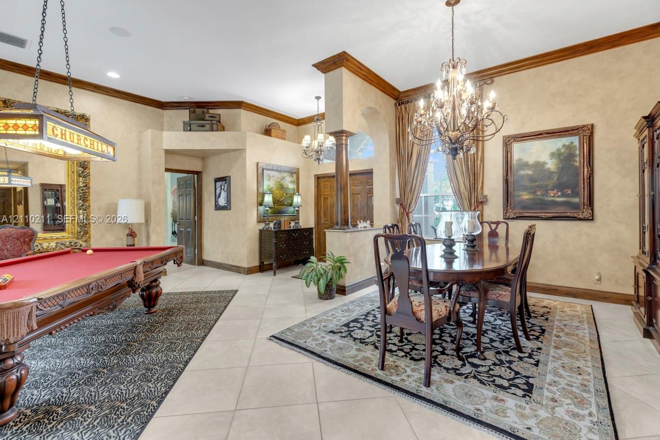Elegant entertainment spaces featuring a crystal chandelier, formal dining area with wood-finish flooring, and a billiards room with traditional styli