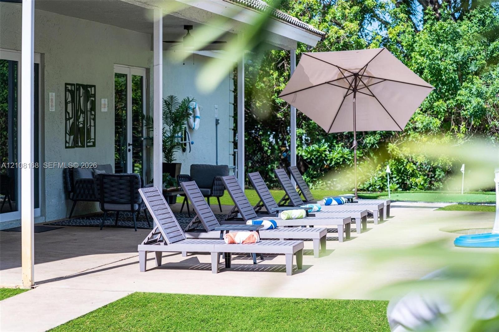 Covered patio featuring a concrete floor, recessed ceiling fan, and access to the grounds via double glass doors