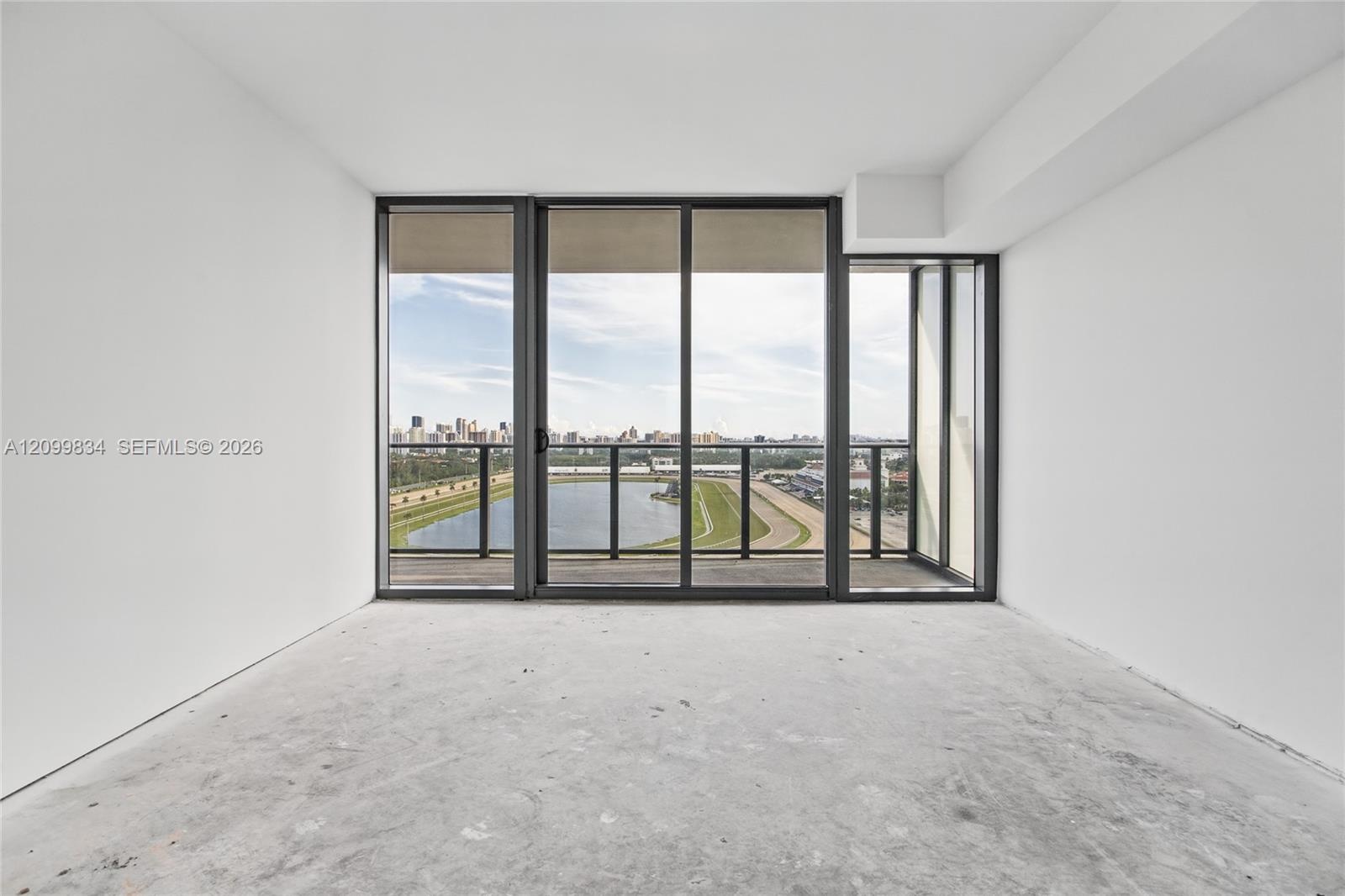 Floor-to-ceiling windows featuring black framing, sliding glass door, and a private balcony with metal railing