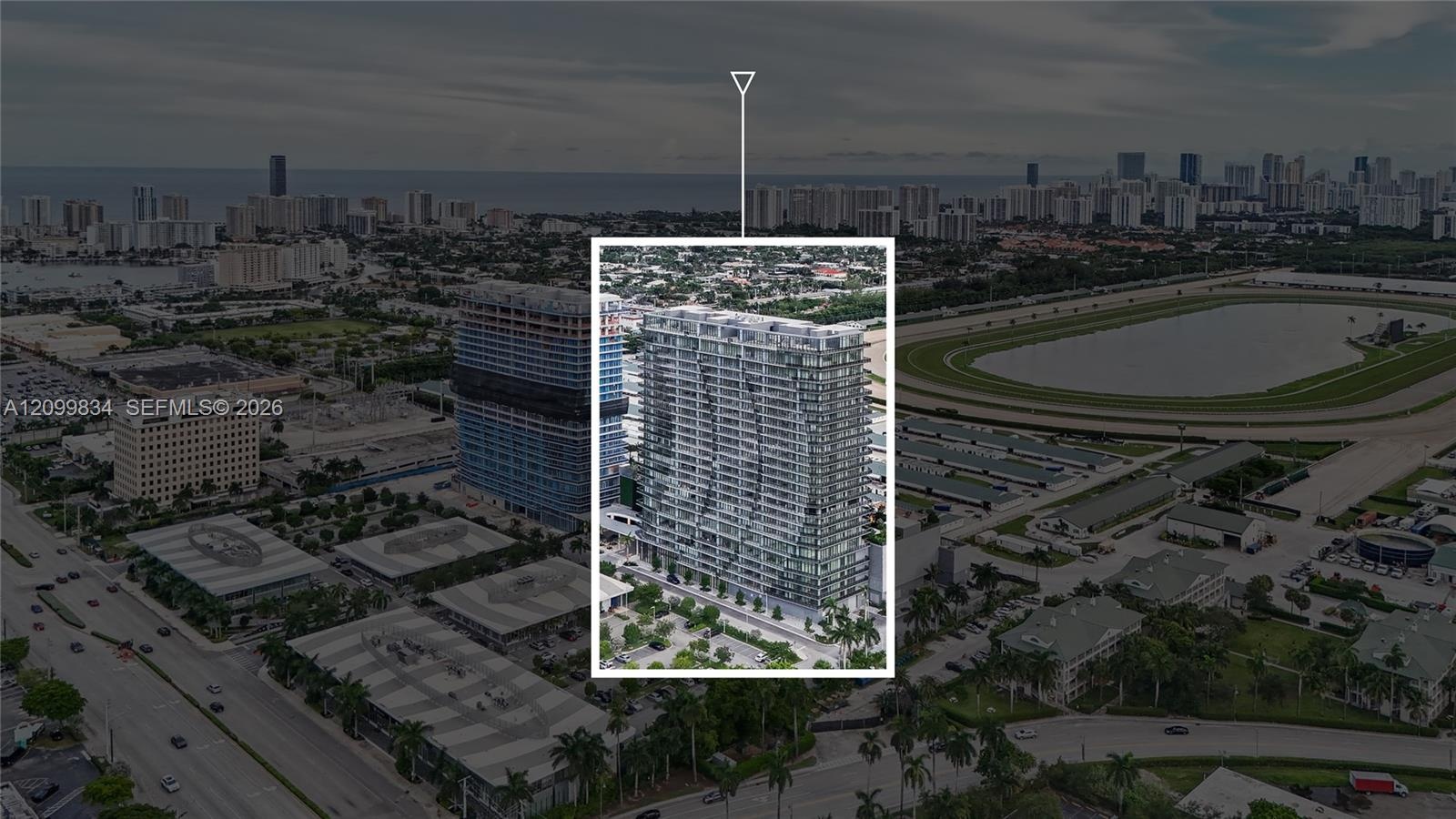 High-rise residential building featuring a curvilinear glass facade, structured balconies, and floor-to-ceiling windows