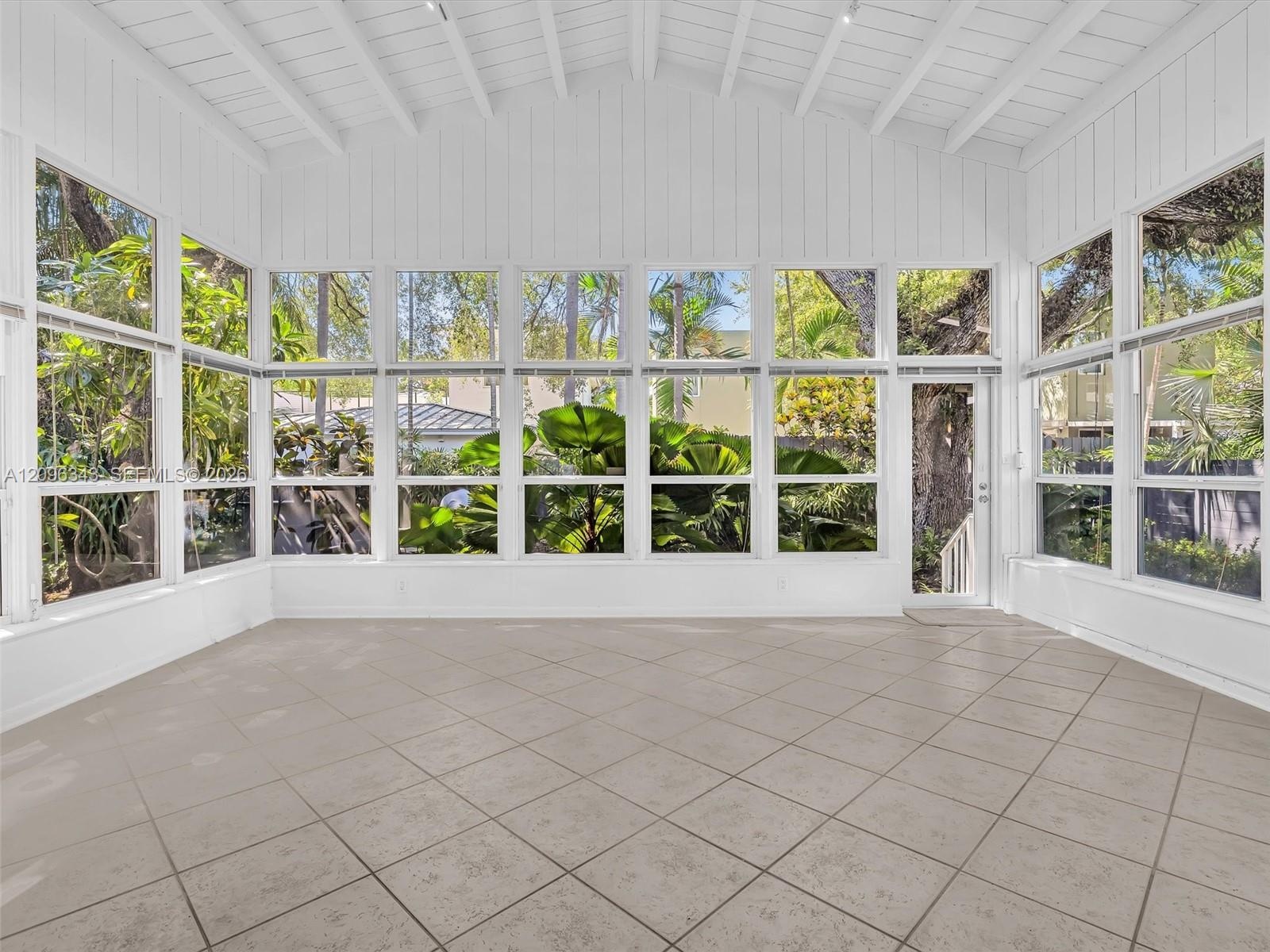 Sunny and private florida room surrounded by nature. Great home for rent in Coconut Grove in Miami, FL. Enjoy large fenced yard, updated home in the N
