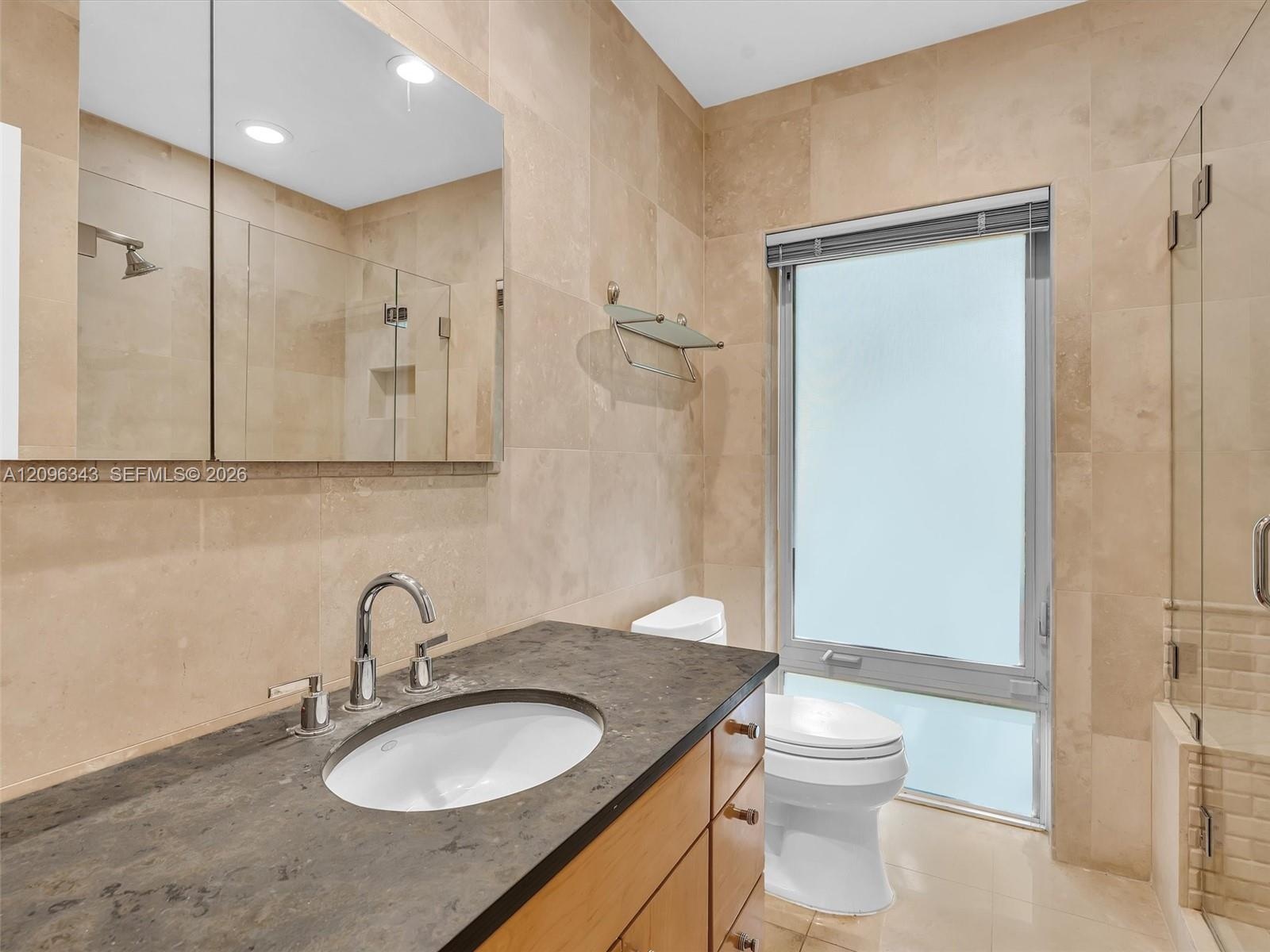 Updated bath in home for rent in Coconut Grove in Miami, FL. Enjoy large fenced yard, updated home in the North Grove. Natoma Manors has 24/7 police p